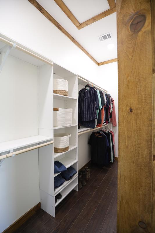 Modular closet with shelves and hanging racks.