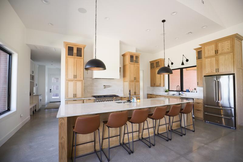 Light stained cabinets and white marble tile island in a spacious kitchen.