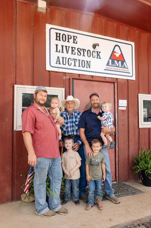 Glen Ford with his son Darrell, Grandson Kade,  and four of his great-grandchildren at the Hope Livestock Auction.