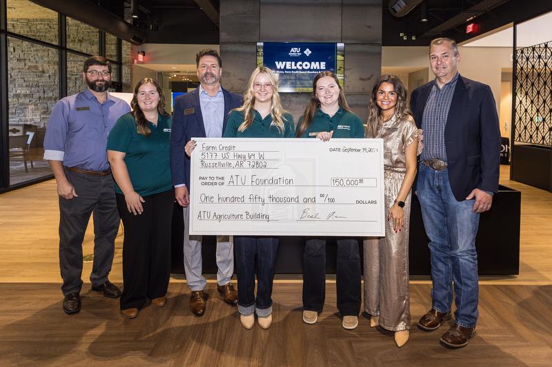 Ambassadors and staff from Arkansas Tech University's Department of Agriculture & Tourism accept the donation check from Farm Credit of Western Arkansas.