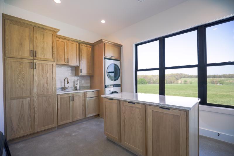 Large laundry room with marble island and big windows