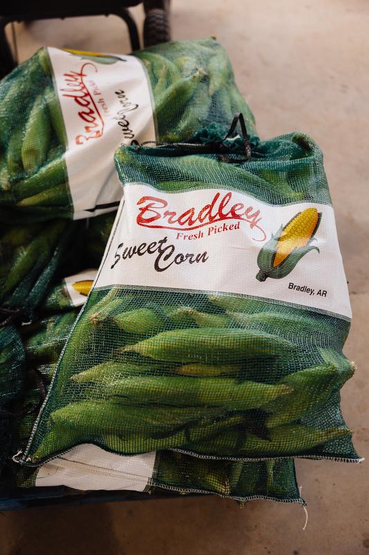 Green mesh bags full of ears of corn