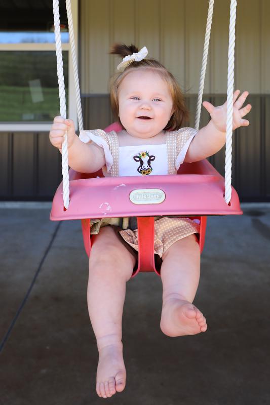 Child in a swing on a porch