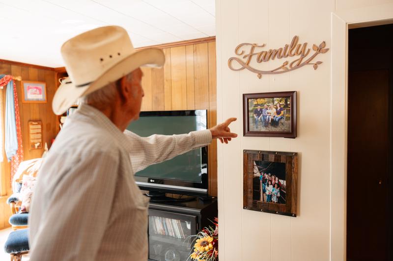 Glen points to photos showing off the  thing he is most proud of—his family.